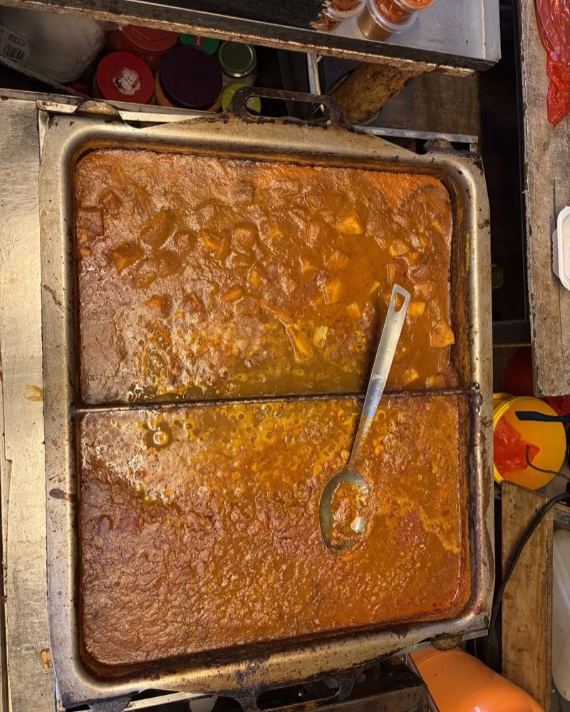 A tray of steaming potato curry at the Fa. Singh stall at the Bötzowmarkt.